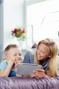 Mother and son playing with digital tablet